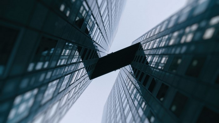 Two modern skyscrapers connected by a skybridge