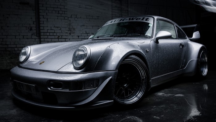 Silver Porsche 911 Carrera RWB with RAUH-Welt banner