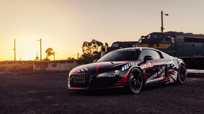 Audi R8 with custom graphics near train