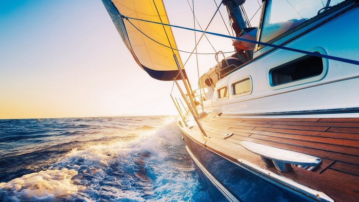 Sailboat sailing on the ocean at sunset
