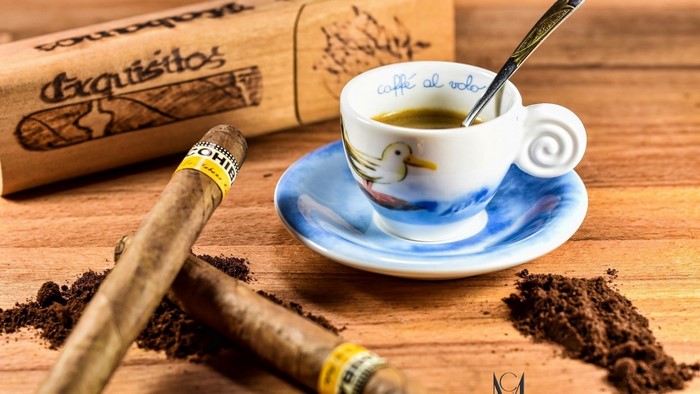 Two Cohiba cigars and a cup of coffee