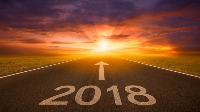 Road with 2018 and arrow towards sunset