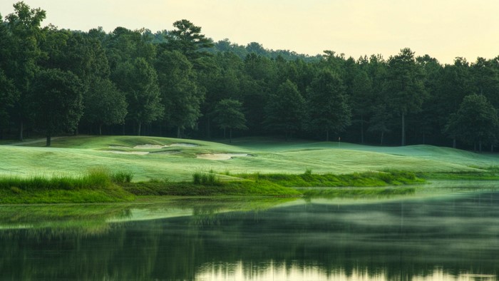 Golf course with lake and forest