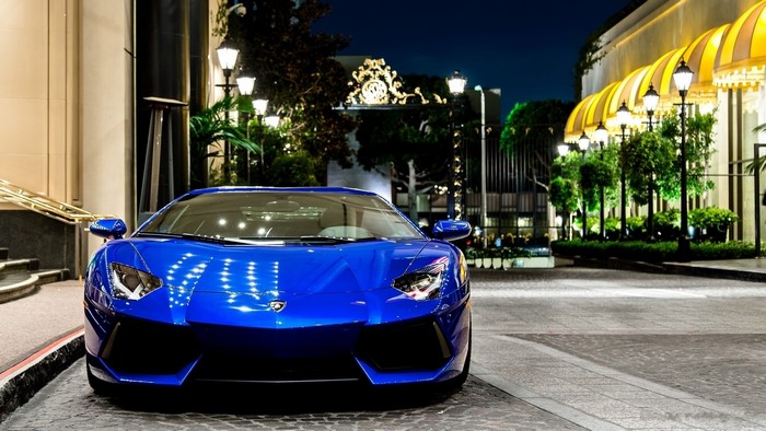 Blue Lamborghini Aventador parked at night