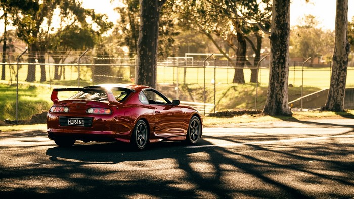 Red Toyota Supra with spoiler
