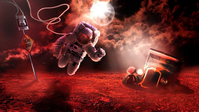 Astronaut floating near Route 66 sign and vintage car
