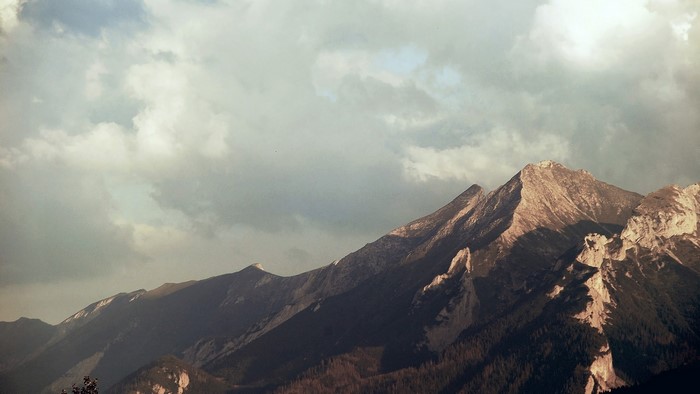 Mountain range under cloudy sky