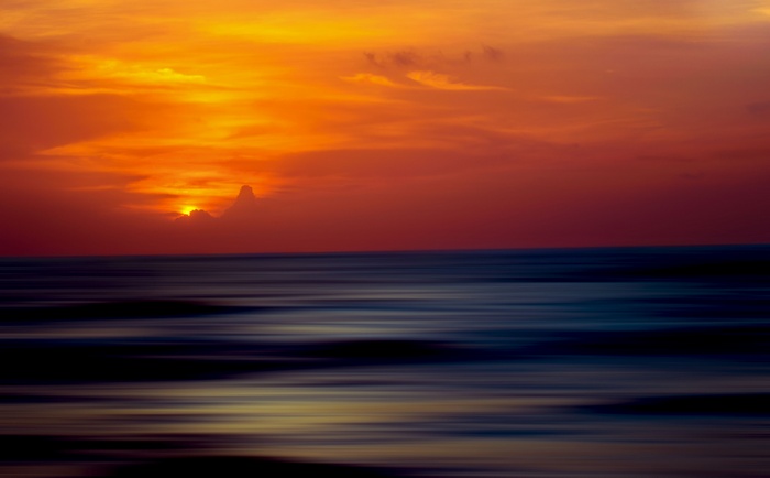 Sunset over the ocean with clouds