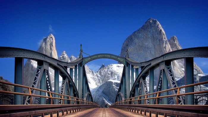 Metal bridge with mountains in the background