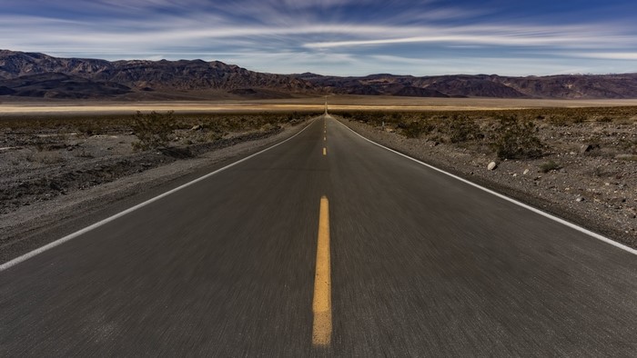 Desert Road Leading to Mountains