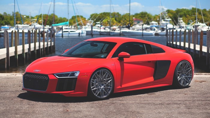 Red Audi R8 parked by a marina