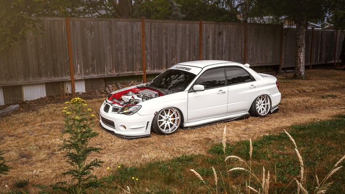 White Subaru Impreza with hood open