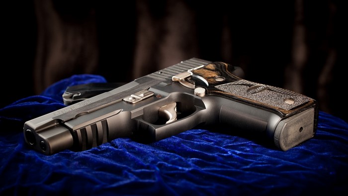 SIG Sauer P226 pistol on blue velvet