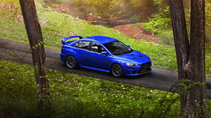 Blue Mitsubishi Lancer Evolution X on a Road