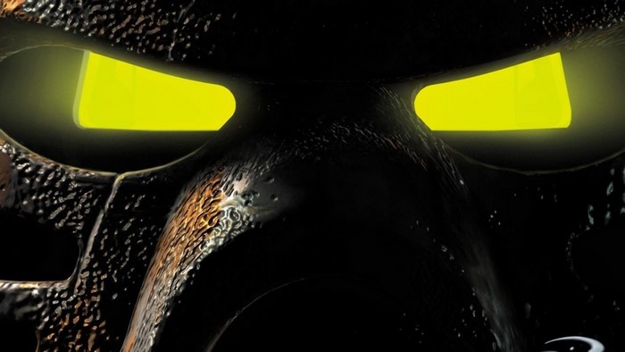Close-up of a Bionicle mask with glowing yellow eyes