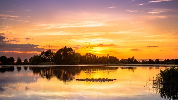 4K Sunset over a Lake with Trees