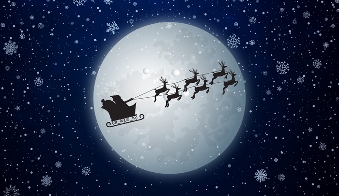 Santa Claus and reindeer sleigh in front of the moon