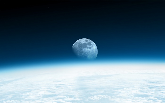 Moon over Earth's atmosphere and clouds