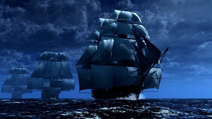 Three tall ships sailing at night