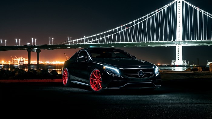 Black Mercedes-Benz S63 Coupe with red wheels at night