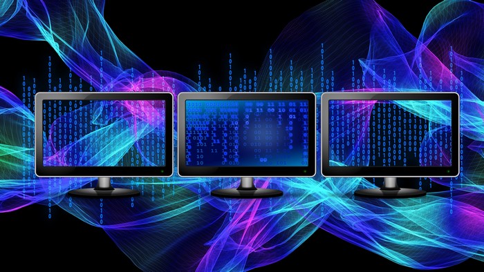 Three 4K Monitors Displaying Binary Code
