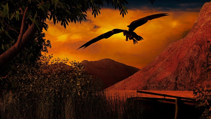 4K Dragon flying over mountains at sunset