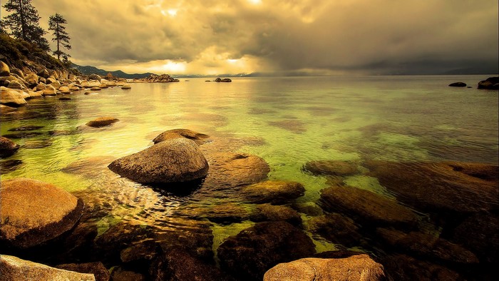Lake with rocks and stormy sky