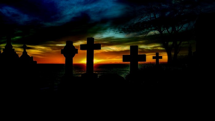 Cemetery crosses at sunset over the ocean