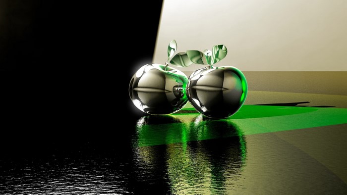 Two chrome apples with green leaves