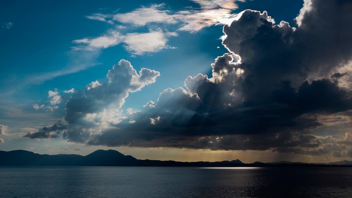 Dramatic clouds over the ocean and mountains