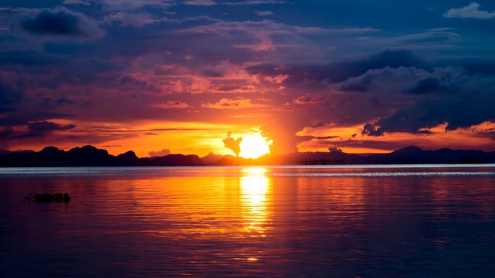 4K Sunset Over Water with Mountains