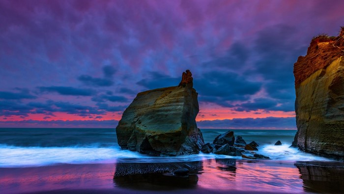 Shoreline with rock formations at sunset