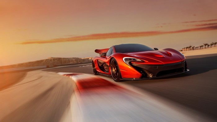 McLaren P1 on a race track at sunset