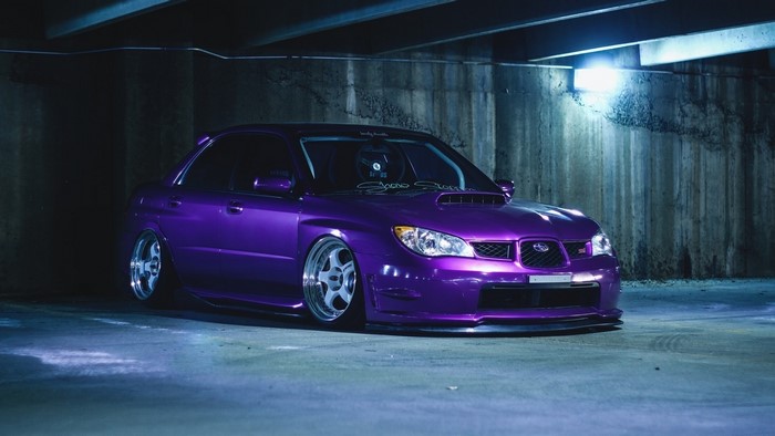 Purple Subaru Impreza WRX STI parked in a concrete structure