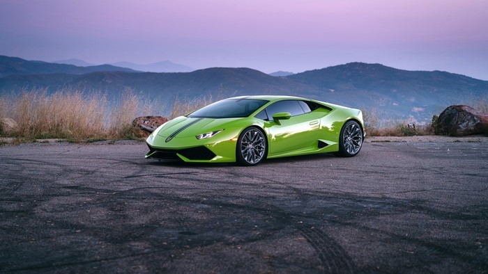 Green Lamborghini Huracan on a mountain road