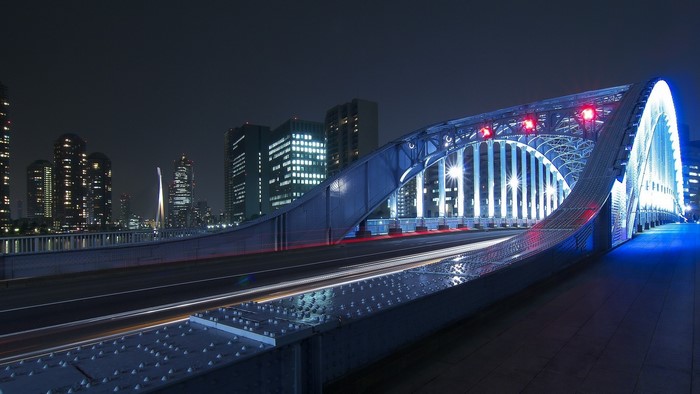 Night view of a modern bridge in Japan with city skyline