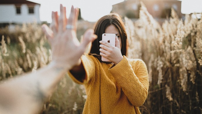 Woman taking a selfie with a smartphone
