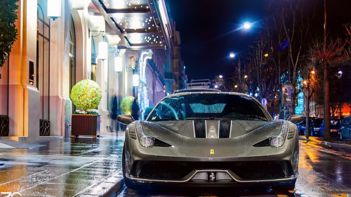 Ferrari 458 parked outside a building at night