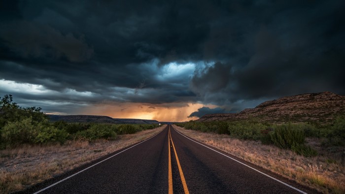 Road under stormy clouds