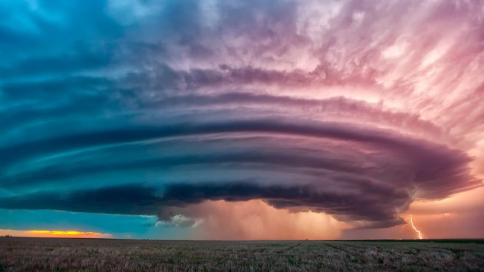 Storm clouds over a field with lightning