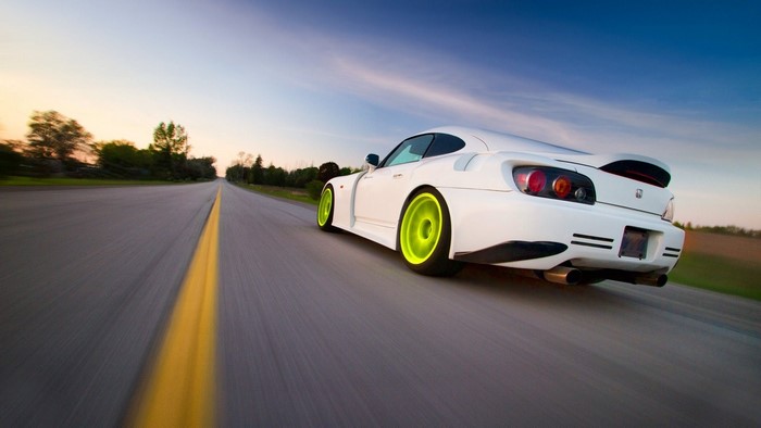 White Honda S2000 driving on a road