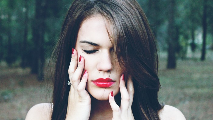 Woman with red lipstick and nails