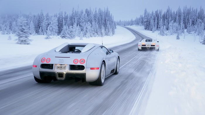 Bugatti Veyron cars driving on a snowy road