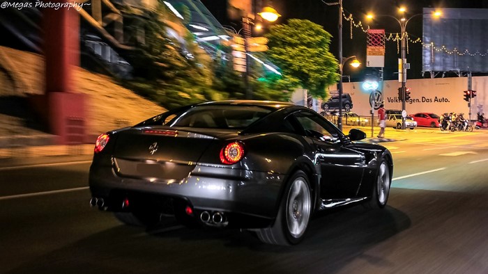 Ferrari driving on a city street at night