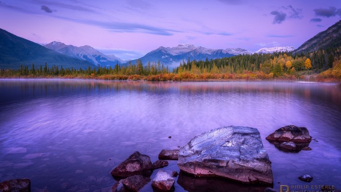 Purple lake and mountains at sunrise