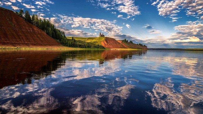 Mezen River in Russia with a church on a hill