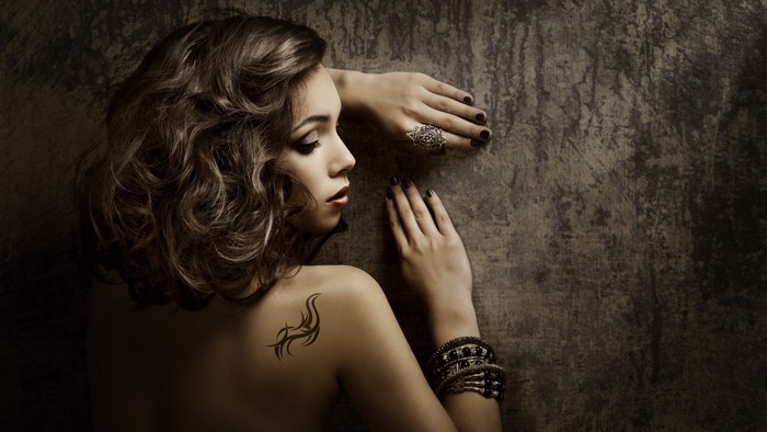 Woman with tattoo and jewelry