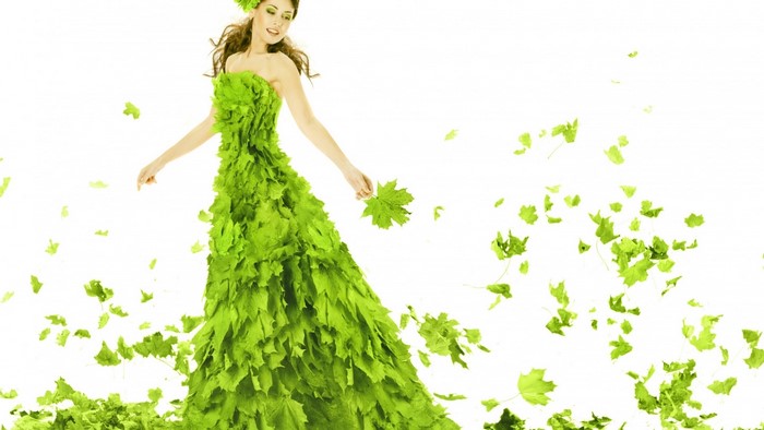 Woman in a dress made of green leaves