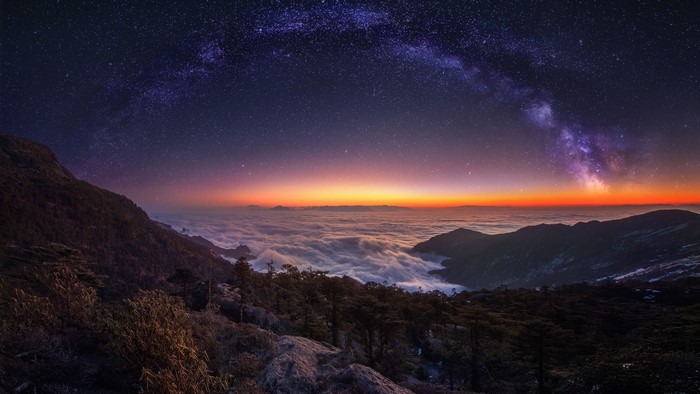 Milky Way over mountains and clouds