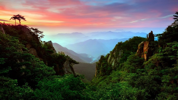 Mountain valley at sunrise with colorful sky